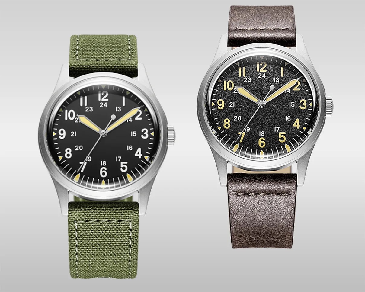 Two wristwatches with black dials and yellow hands, one with a green fabric strap and the other with a brown leather strap.
