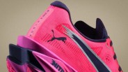 Close-up of a pink Puma running shoe with black and silver logo and black interior lining.