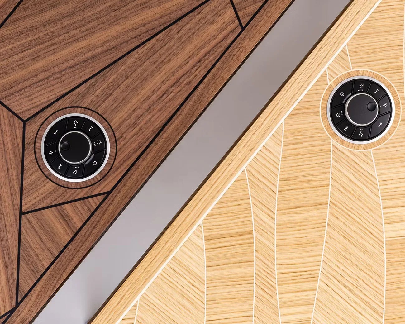 Close-up of two wooden surfaces with geometric patterns, each featuring a circular black control dial with buttons.