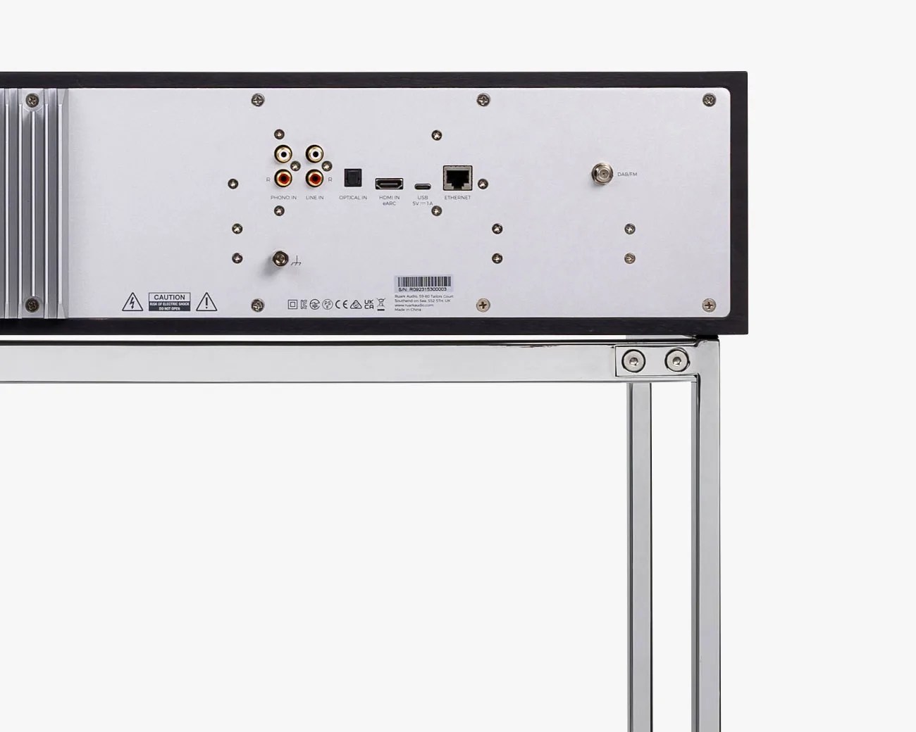 Back panel of a black audio device with RCA, optical, HDMI, USB, Ethernet, and DAB/FM antenna ports on a metal stand.