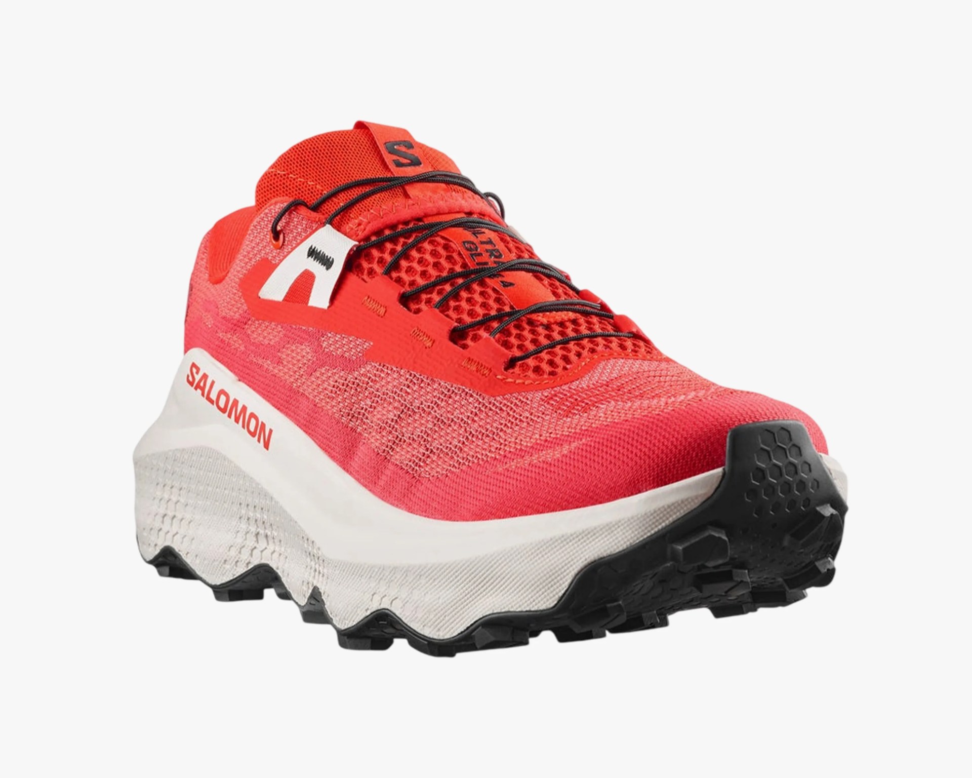 a red and white salomon shoe seen from the front
