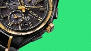 Close-up of a black and gold Seiko Astron GPS Solar watch face with textured dial and multiple subdials.