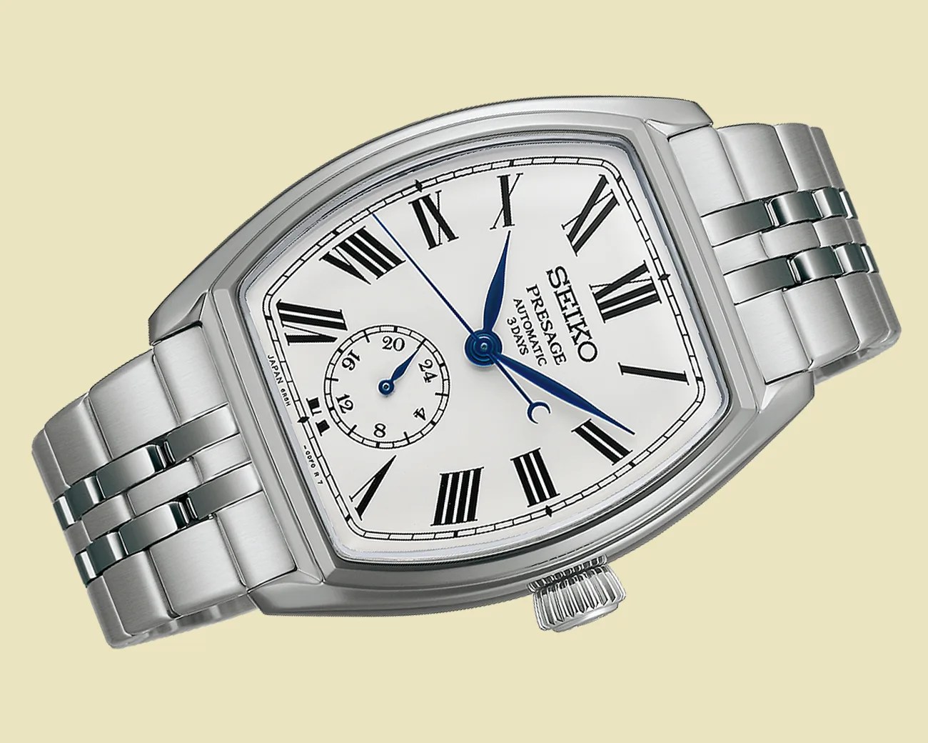 Silver Seiko Presage automatic wristwatch with white dial, blue hands, Roman numerals, and stainless steel bracelet.