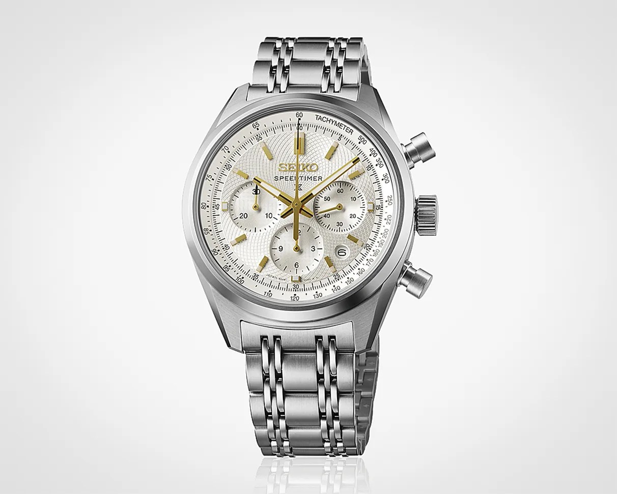 Silver Seiko Speedtimer chronograph watch with white dial, gold-tone hands and markers, and stainless steel bracelet.