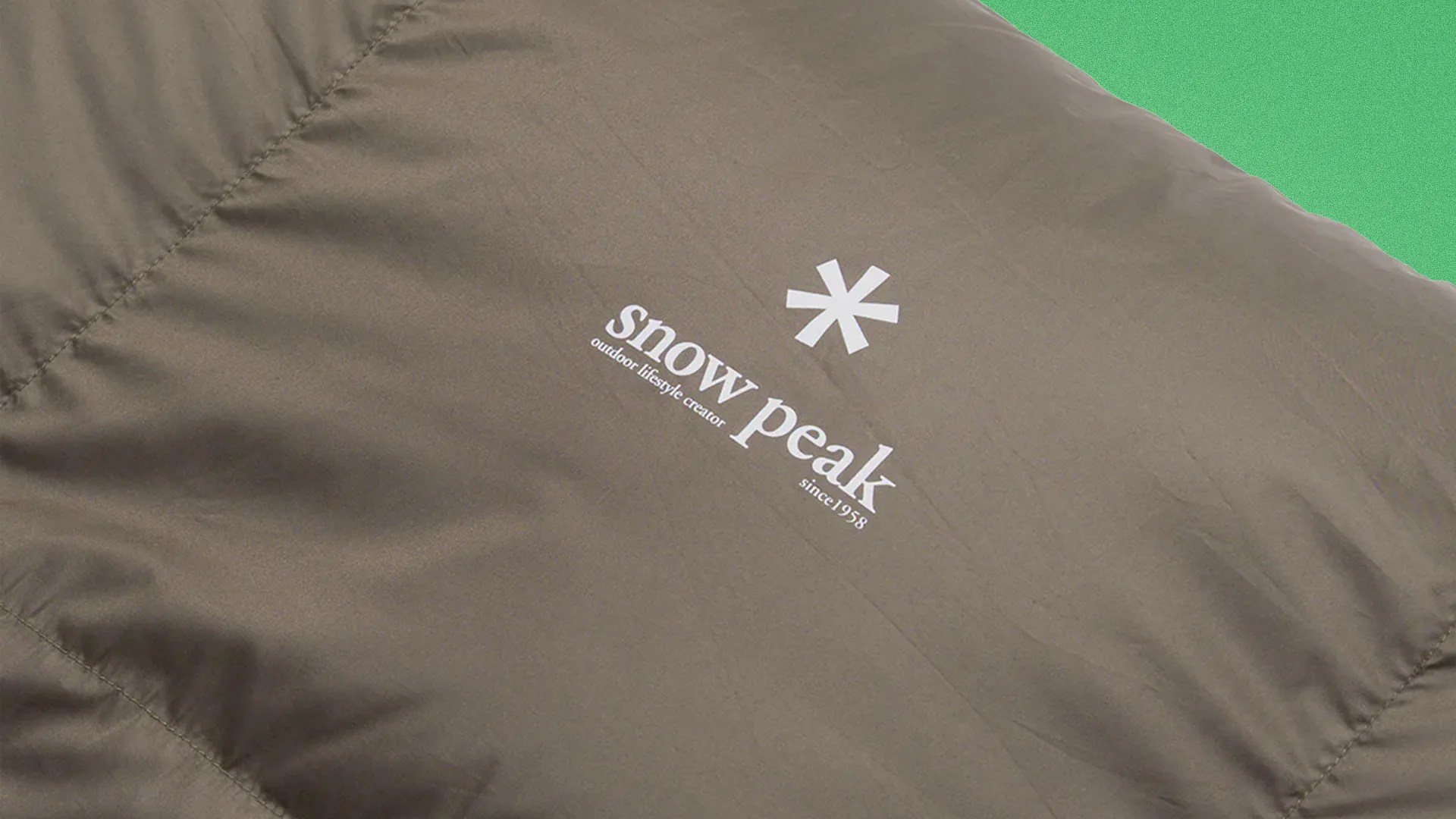 Brown fabric with white "snow peak outdoor lifestyle creator since 1958" logo and asterisk symbol.