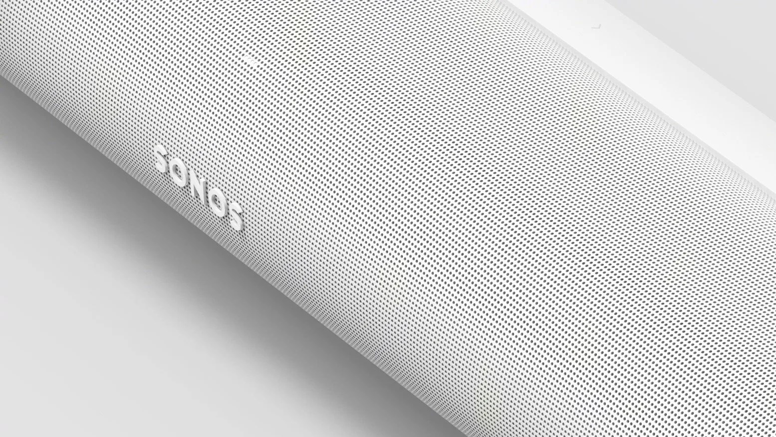 White Sonos speaker with perforated grille surface angled on a white background.
