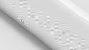 White Sonos speaker with perforated grille surface angled on a white background.