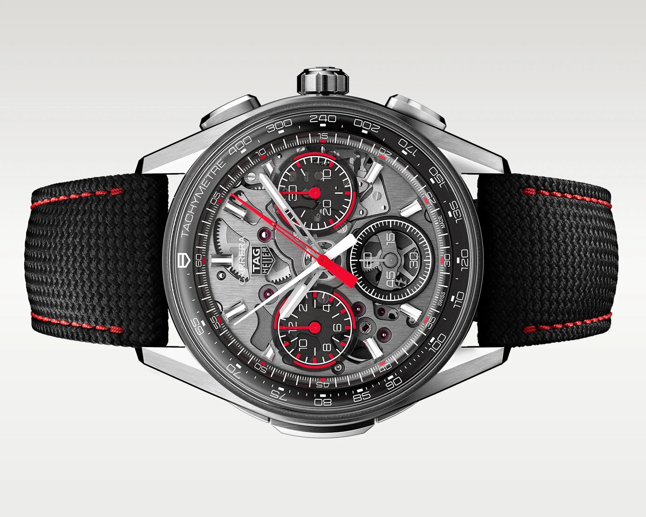 TAG Heuer Carrera chronograph watch with black textured strap, red stitching, and skeleton dial showing gears.