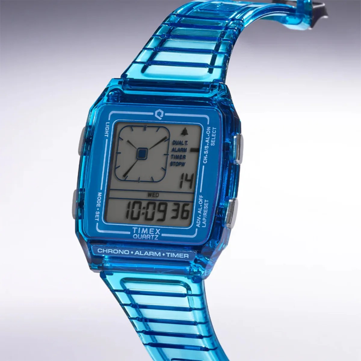 Blue transparent Timex digital watch with square face displaying time and date.