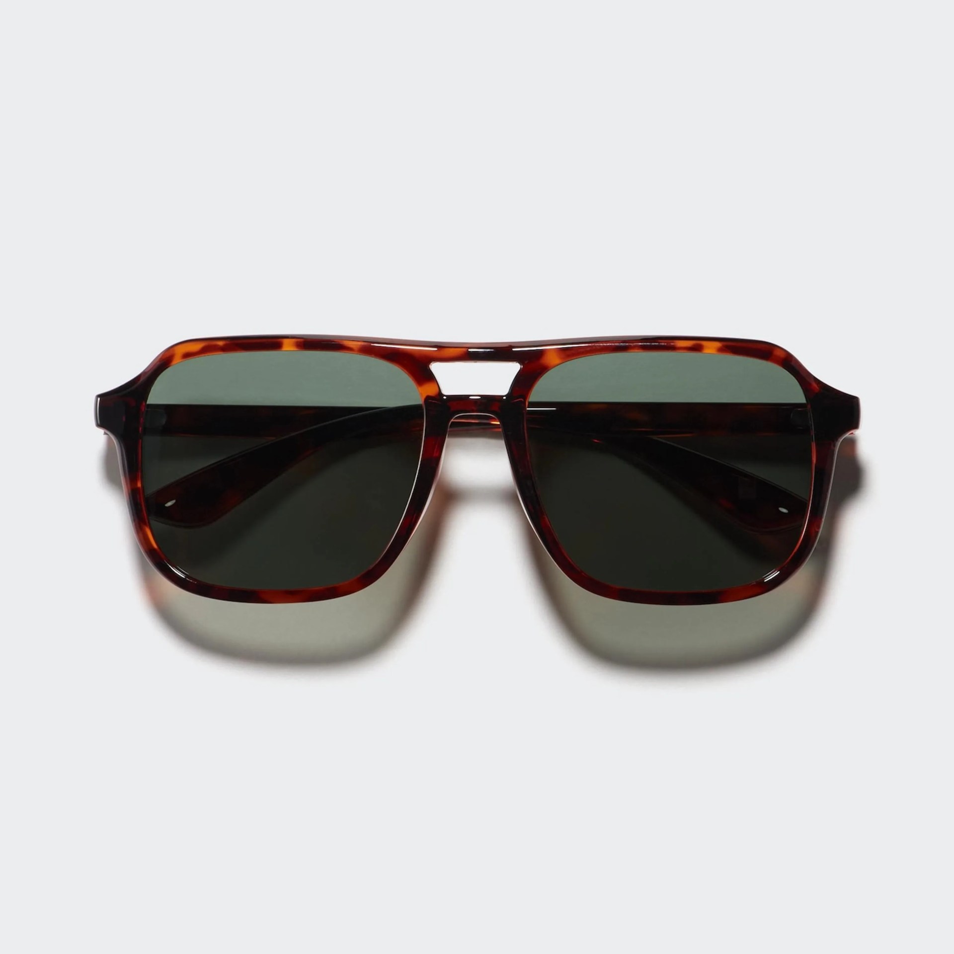 Tortoiseshell rectangular sunglasses with dark green lenses on a white background.