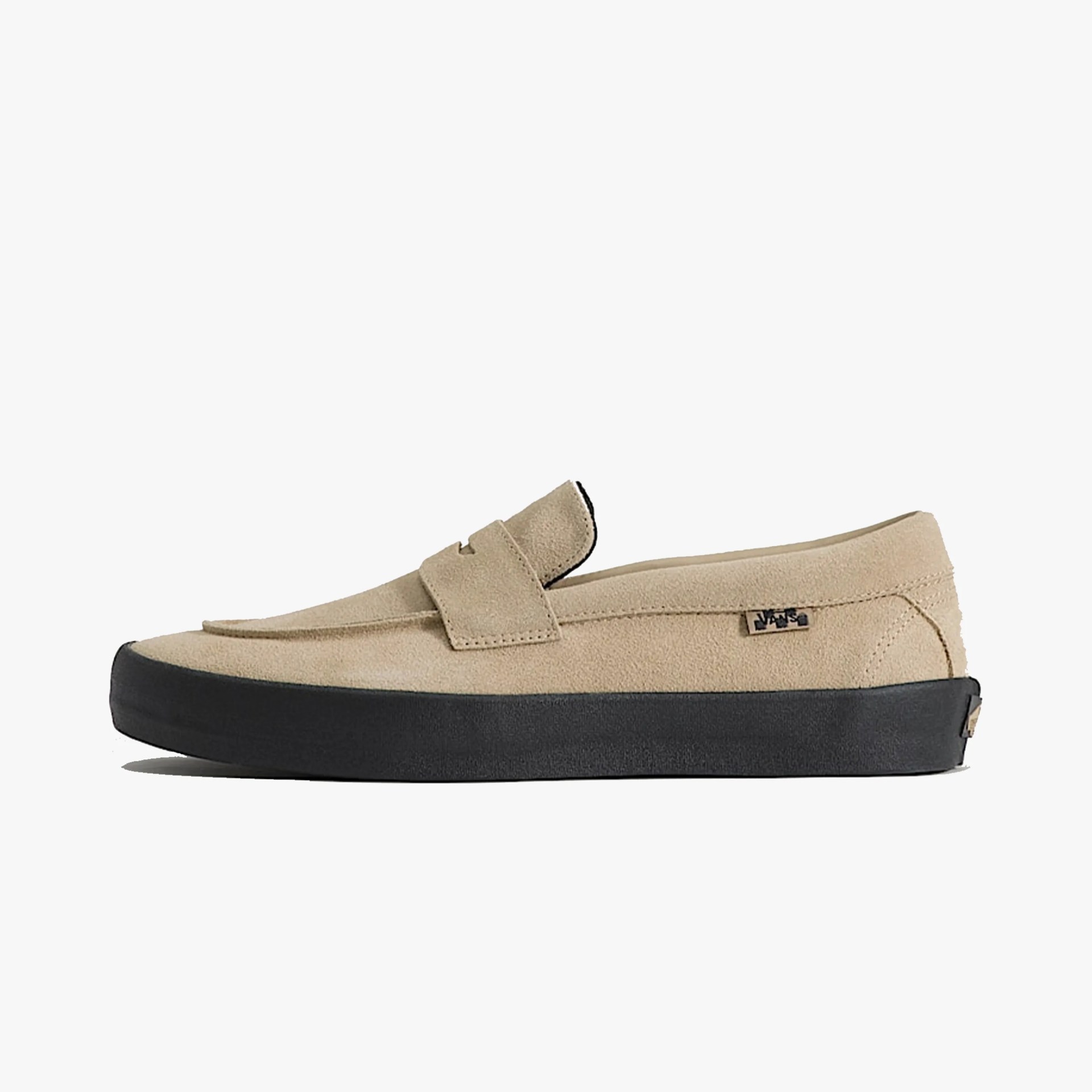 Beige suede slip-on loafer with black rubber sole and small Vans logo tag on the side.