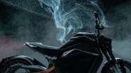 Black electric motorcycle with orange cables and blue smoke effect in the background.