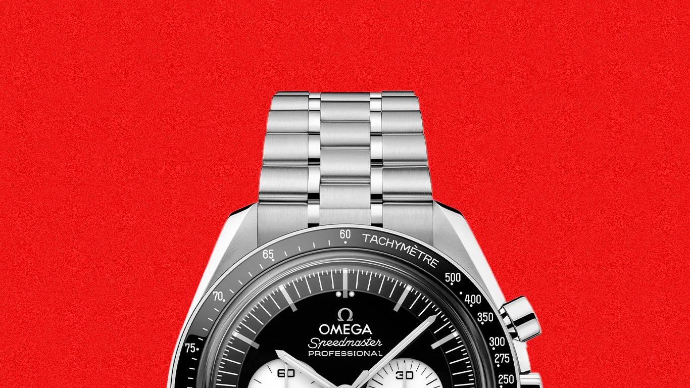 Silver Omega Speedmaster Professional watch with black dial and tachymeter bezel on a red background.