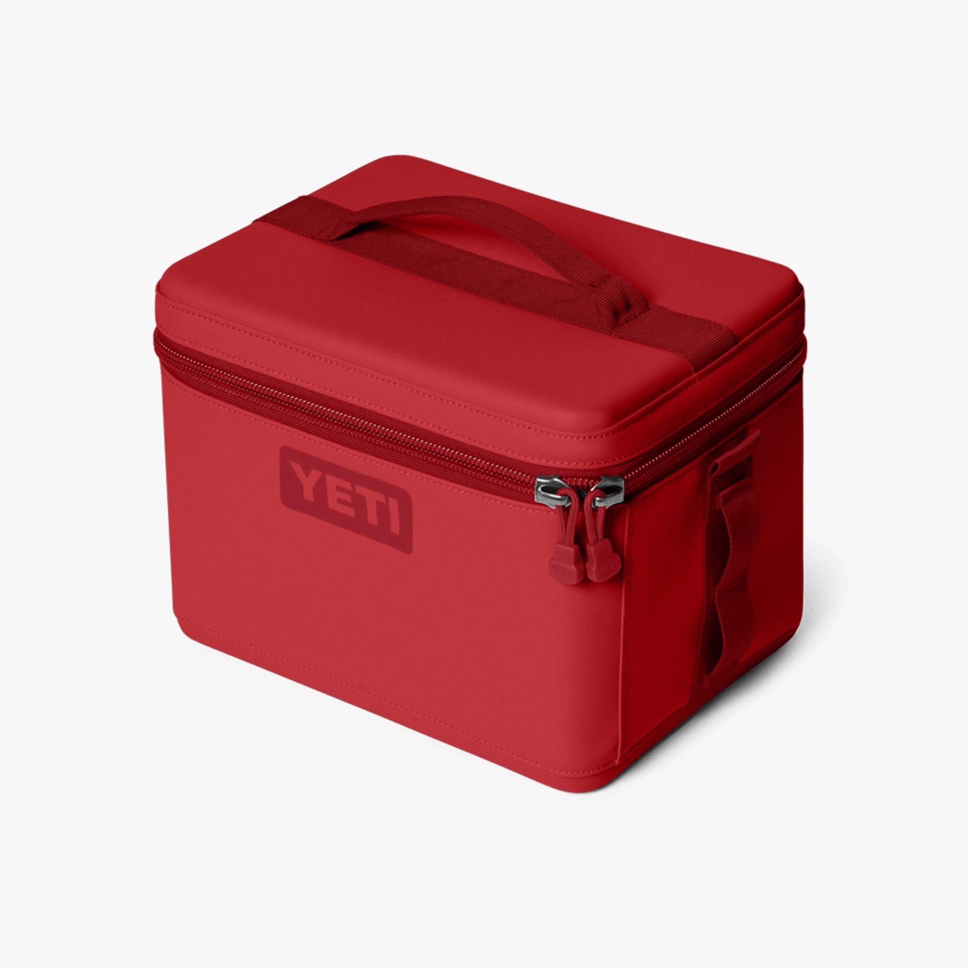 Red rectangular YETI soft cooler bag with zipper and top handle on a white background.