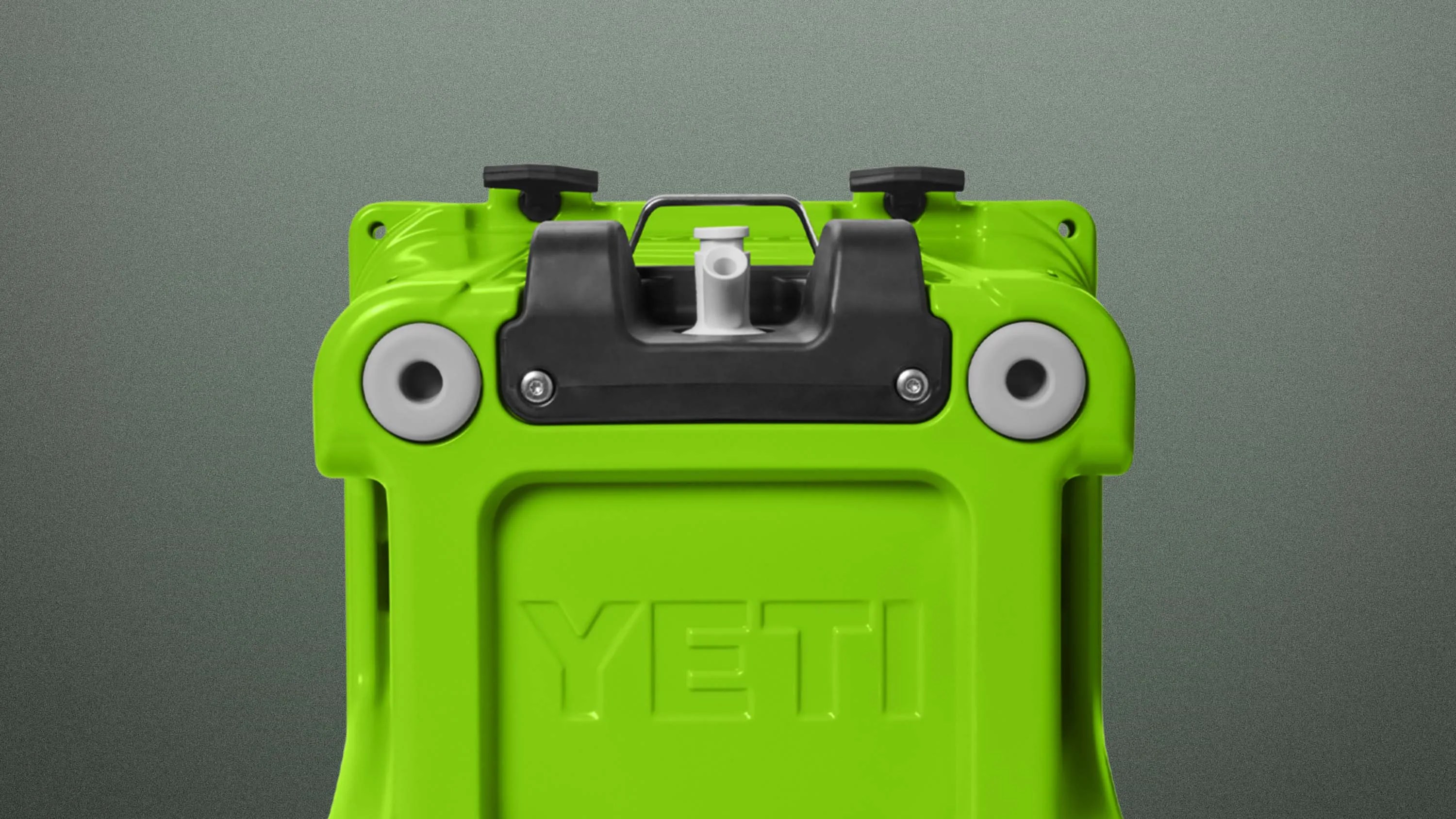Bright green YETI cooler lid with black latch and white drain plug on a gray background.