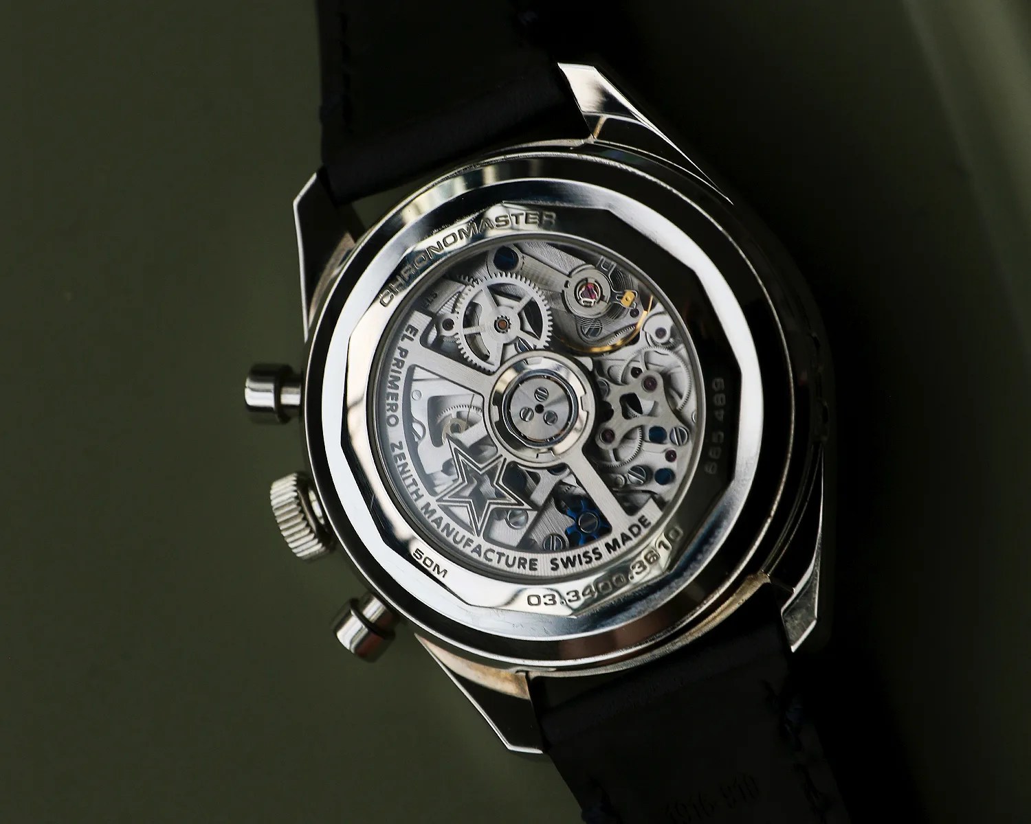 Back of a Zenith Chronomaster watch showing the intricate mechanical movement through a transparent case back.
