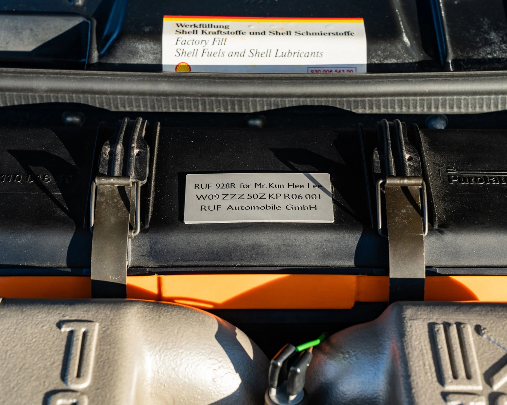 Metal plaque on a black engine component with text "RUF 928R for Mr. Kun Hee Lee" and "RUF Automobile GmbH.
