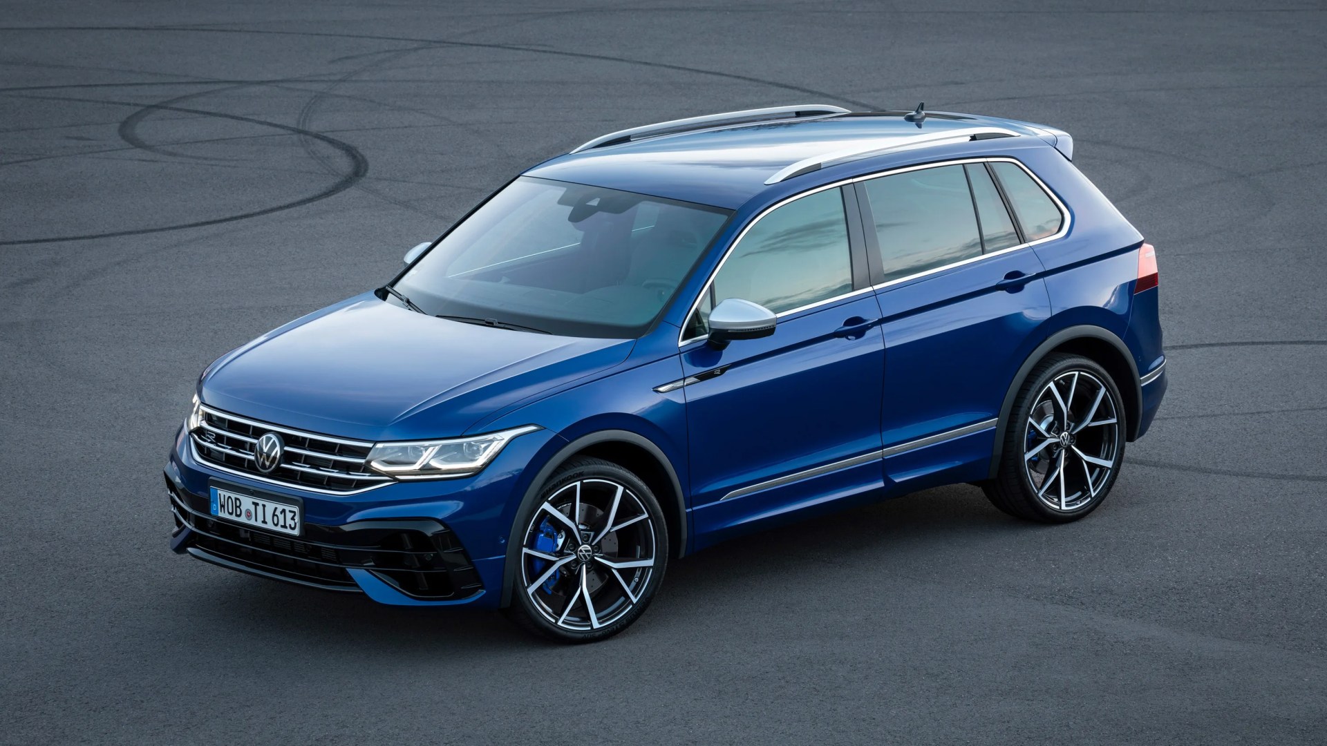 Blue Volkswagen SUV with black and silver alloy wheels parked on asphalt.