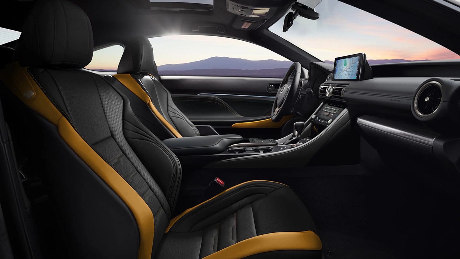 Black and mustard leather car seats with a black dashboard and touchscreen navigation display.