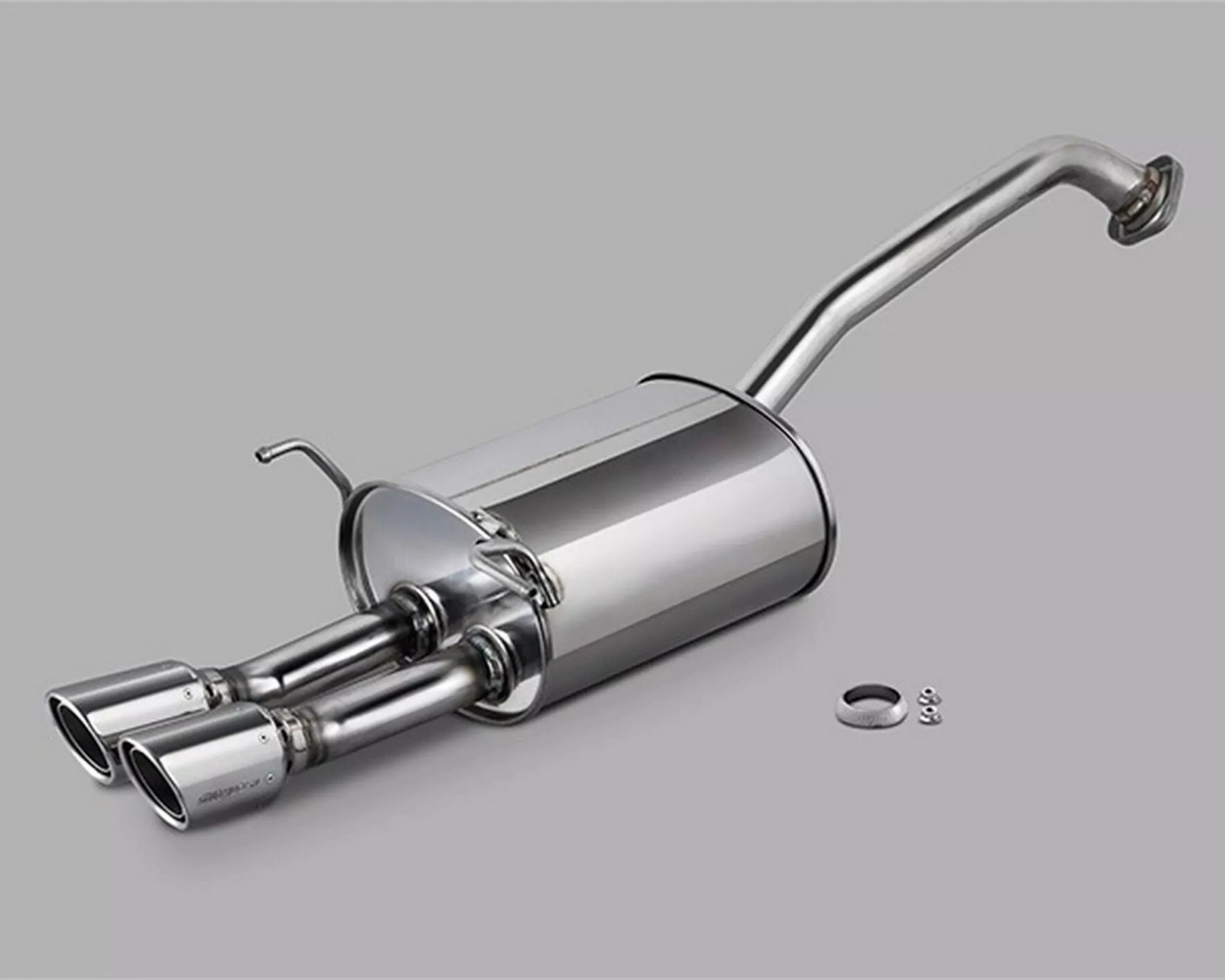 Polished stainless steel dual exhaust muffler with curved inlet pipe and mounting hardware on a gray background.