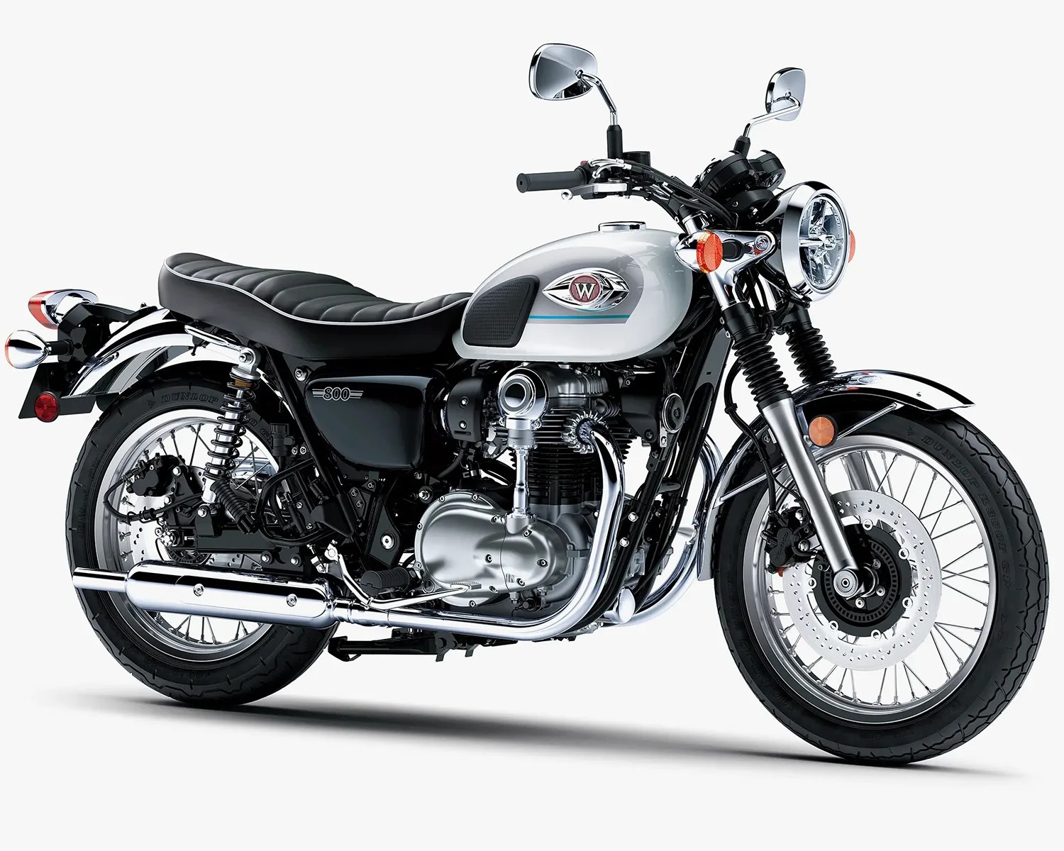 White and black classic-style motorcycle with chrome exhaust and round headlight on a white background.