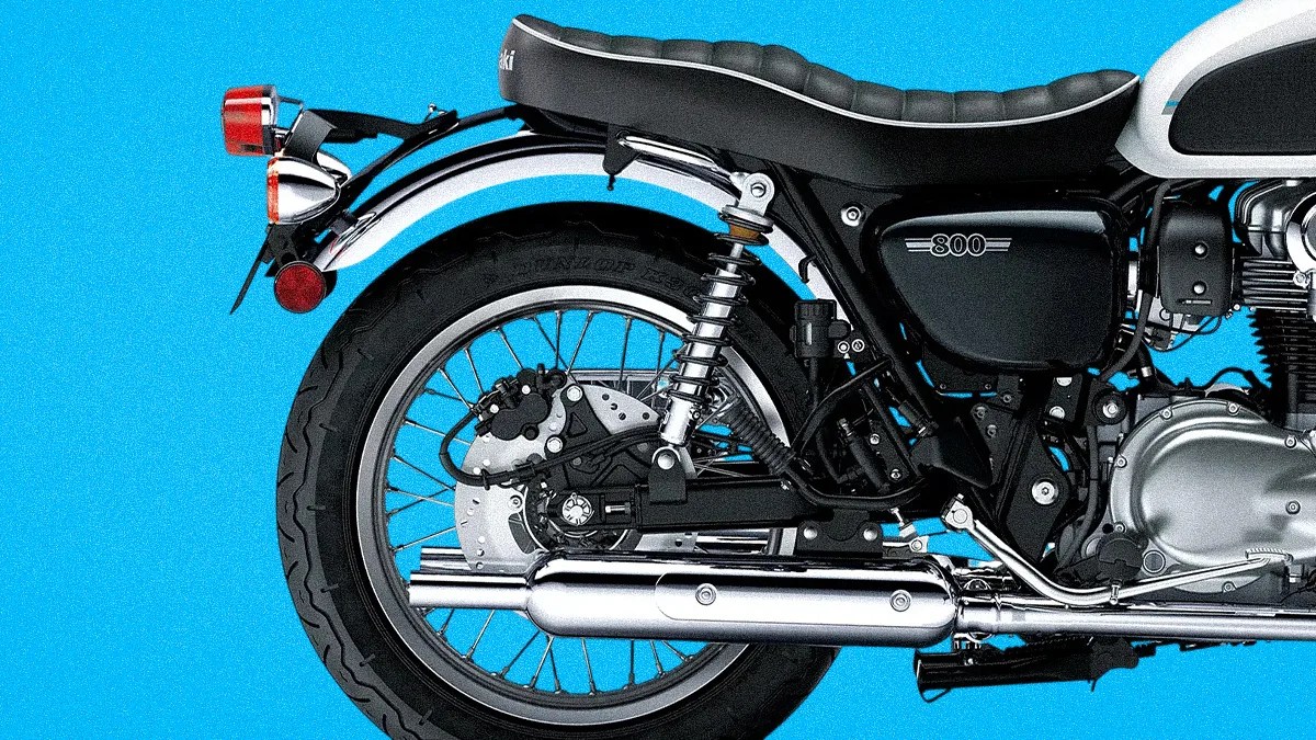 Rear section of a black and silver Kawasaki 800 motorcycle against a blue background.