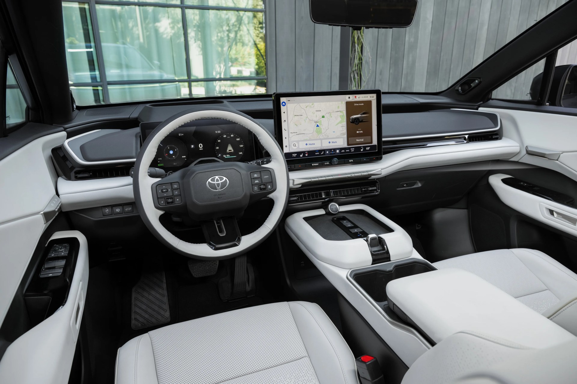 Interior of a modern Toyota car with white leather seats, digital dashboard, and central touchscreen display.