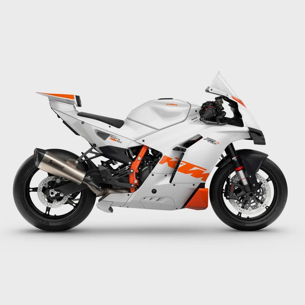 White and orange KTM sport motorcycle with black wheels and Akrapovic exhaust on a white background.