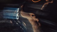 Brown and black cycling shoe with "510" logo on the heel, illuminated by streaks of light.