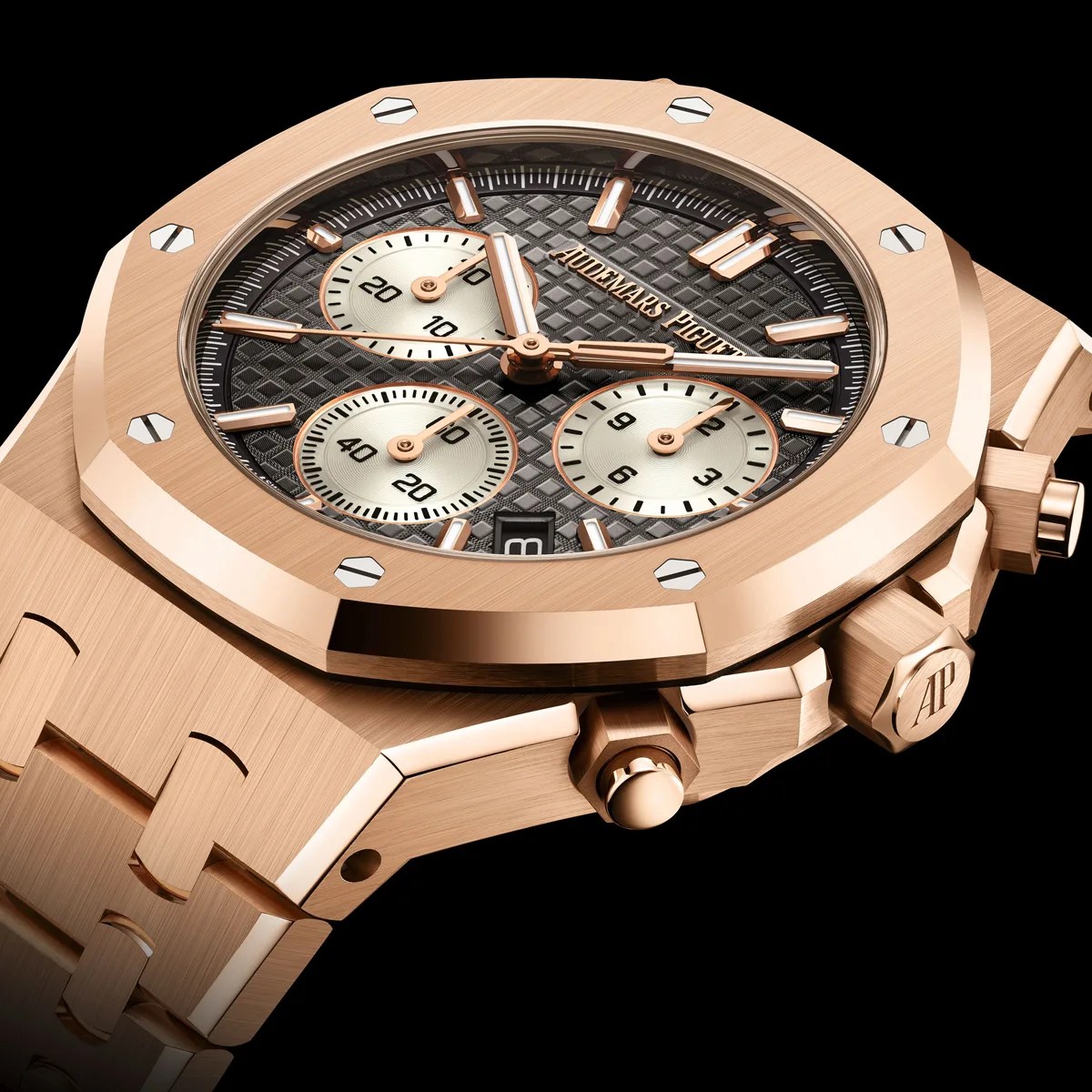 Rose gold Audemars Piguet chronograph watch with black textured dial and three subdials on a matching bracelet.