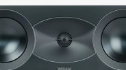 Close-up of a black ARCAM speaker with two large drivers and a central tweeter.