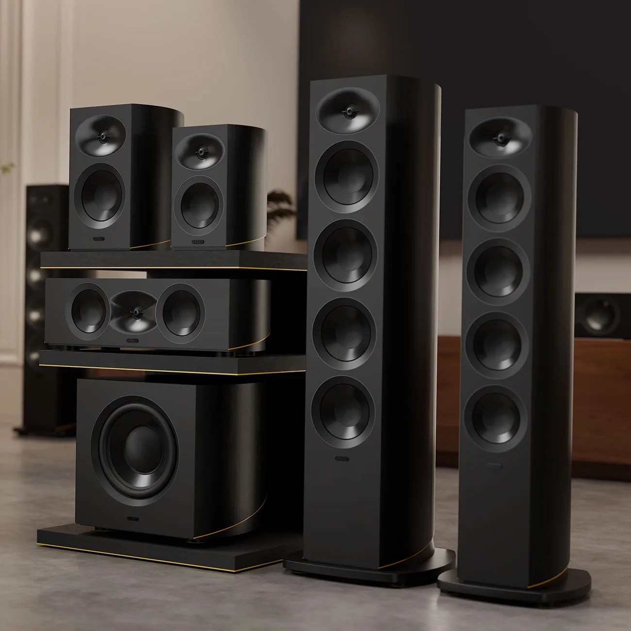 Set of black floor-standing and bookshelf speakers with gold trim, including subwoofer and center channel speaker.