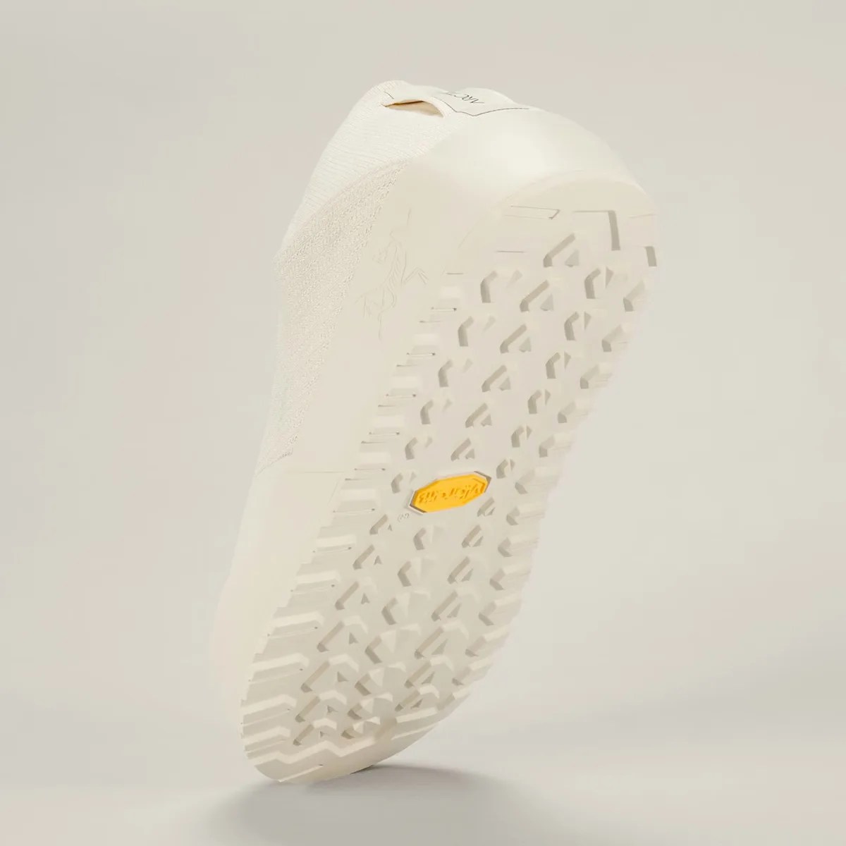 Off-white sneaker sole with a textured tread pattern and a yellow Vibram logo in the center.