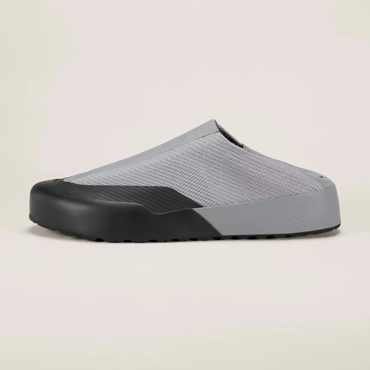 Gray slip-on shoe with black rubber toe cap and sole, featuring a textured upper and low heel.
