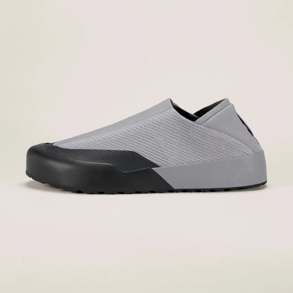 Gray slip-on sneaker with black rubber toe cap and sole, featuring a textured knit upper.
