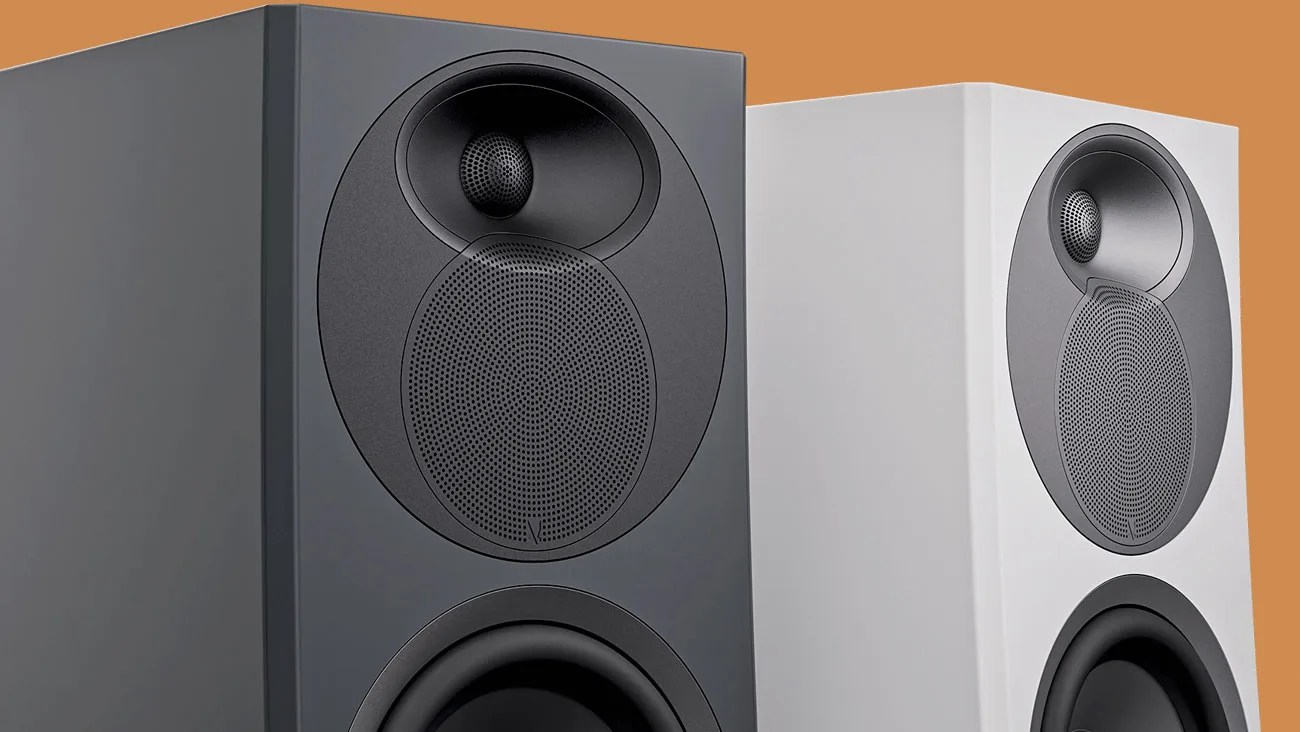 Pair of modern bookshelf speakers, one matte black and one matte white, with circular drivers and tweeters.