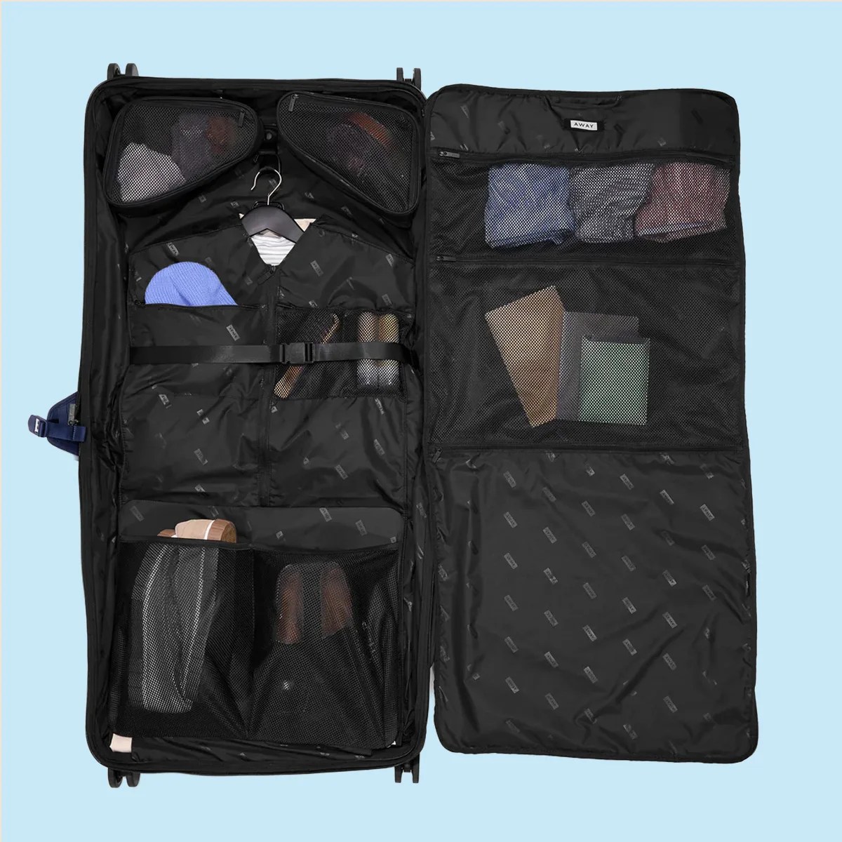 Open black suitcase with organized compartments holding folded clothes, shoes, and accessories on a light blue background.