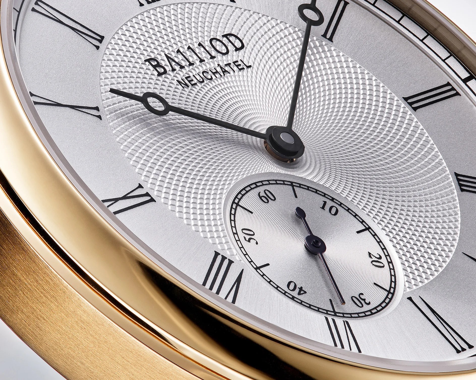 Close-up of a gold watch face with Roman numerals, black hands, textured silver dial, and a small seconds subdial.