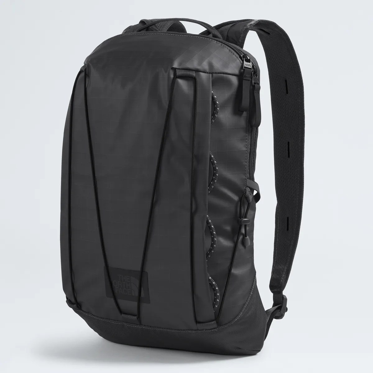 Black rectangular backpack with padded shoulder straps and elastic cord detail on the front.