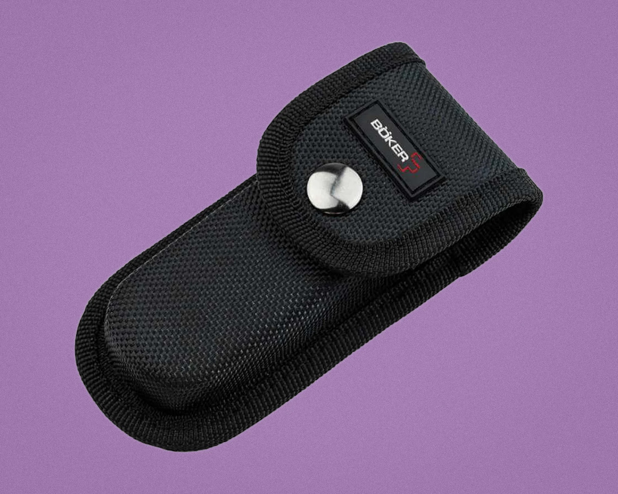 Black textured nylon Boker knife pouch with flap and metal snap button on a purple background.