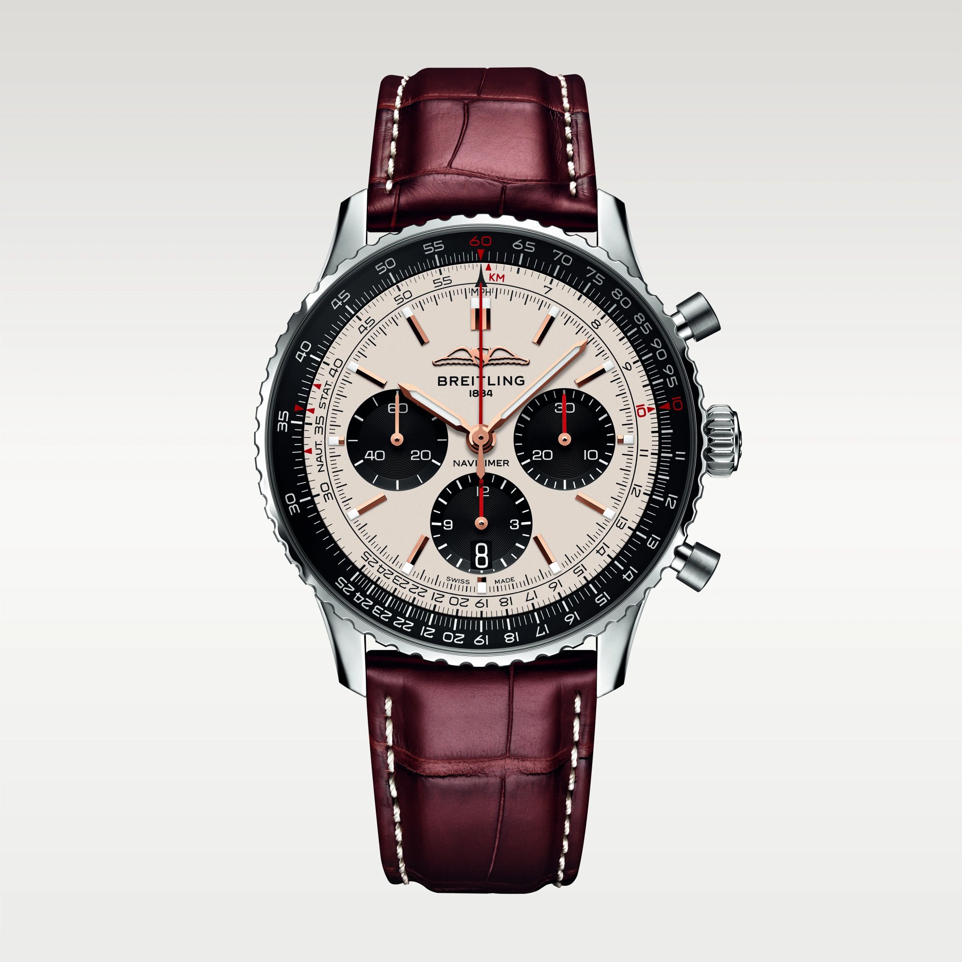 Breitling Navitimer watch with silver case, cream dial, black subdials, and burgundy leather strap with white stitching.