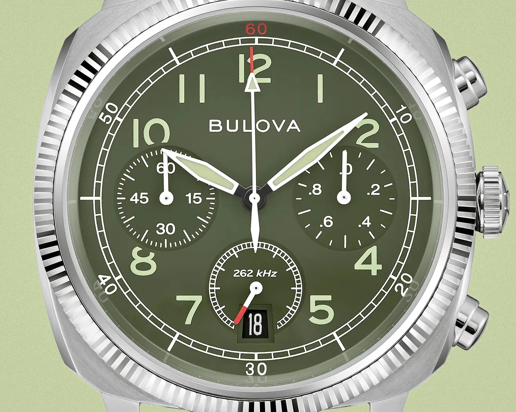 Close-up of a Bulova watch face with an olive green dial, silver hands, and chronograph subdials.