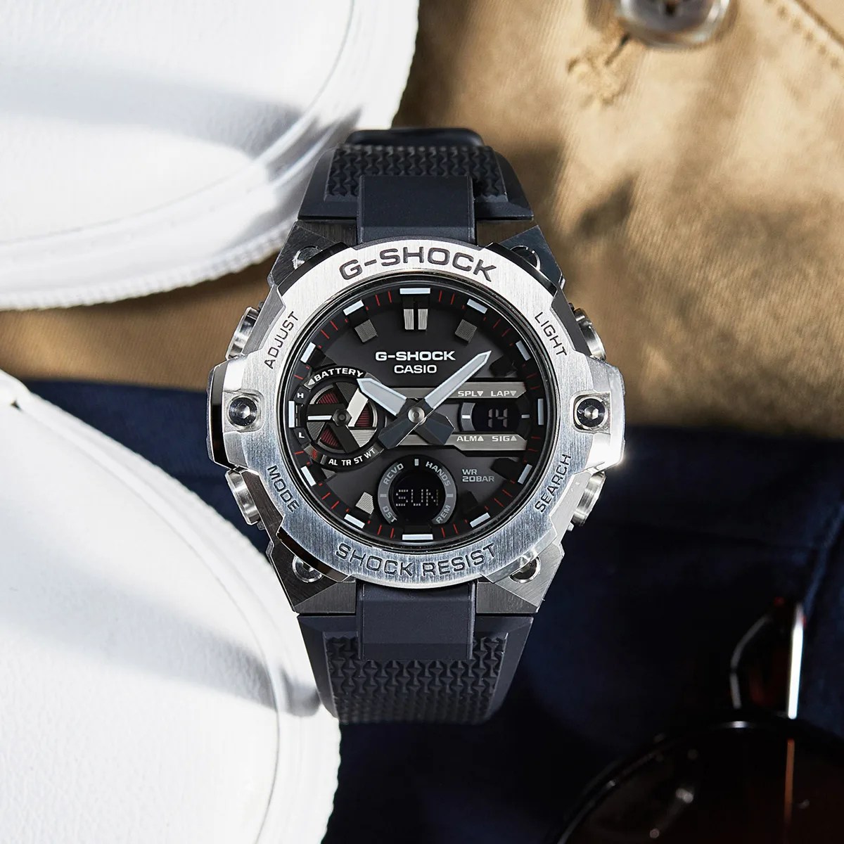 Black and silver Casio G-Shock watch with digital and analog display and black textured strap.