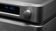 Close-up of a silver Esoteric audio device with a blue digital display showing "DSD 22.5 MHz" and a large volume knob.