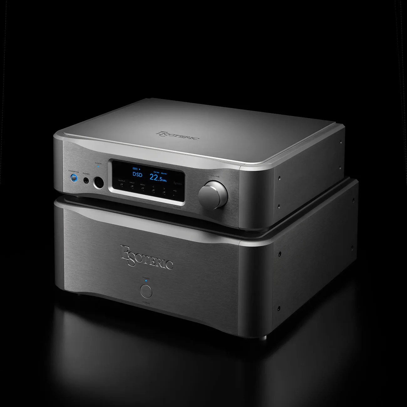 Stacked Esoteric audio components with brushed metal finish, digital display, and control knob on a black surface.