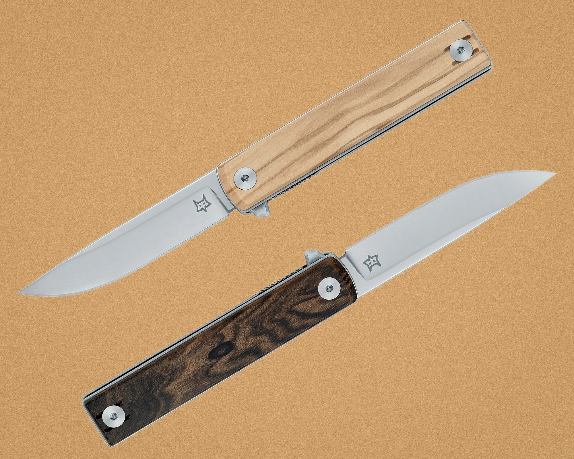 Two folding knives with stainless steel blades and wooden handles, one light wood and one dark wood, on a tan background.