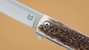 Folding knife with a stainless steel blade featuring a fox logo and a textured brown handle.