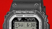 Close-up of a black Casio digital watch face with "PROTECTION" and "ILLUMINATOR" text on a red background.