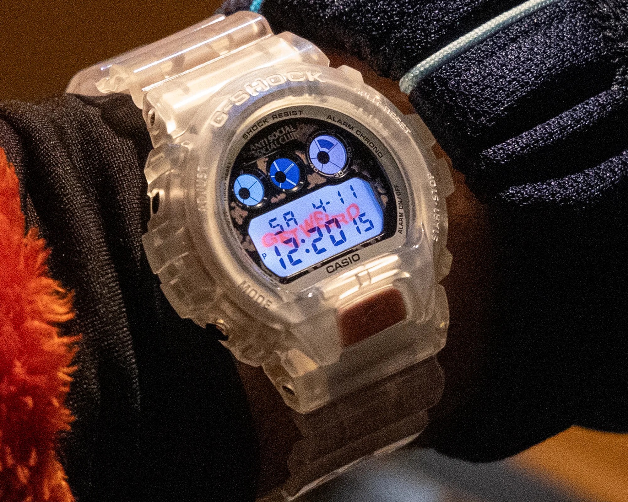 Transparent Casio G-Shock digital watch with blue and black dial details worn on a wrist.