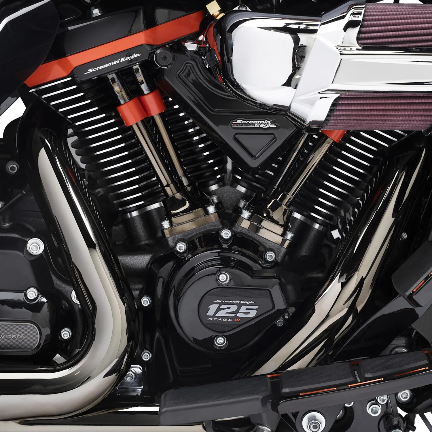 Close-up of a black and chrome Screamin' Eagle 125 Stage III motorcycle engine with visible air filters and exhaust pipes.